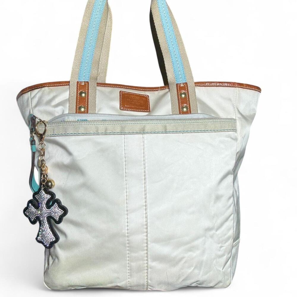 Coach cream Hampton bag with light blue inside and cross charm.